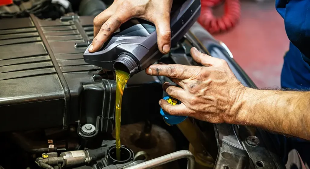 pouring oil into engine