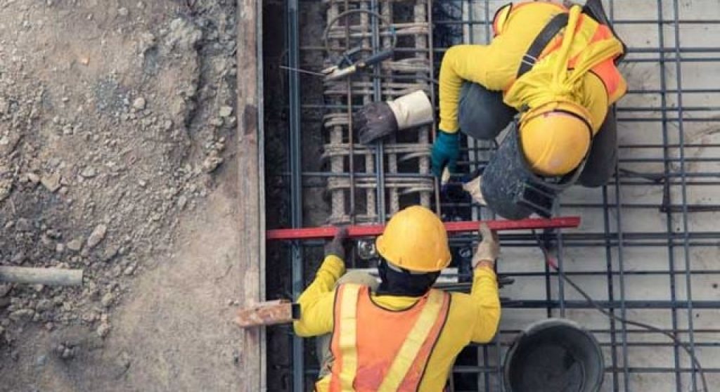 aerial view of a construction site and workers