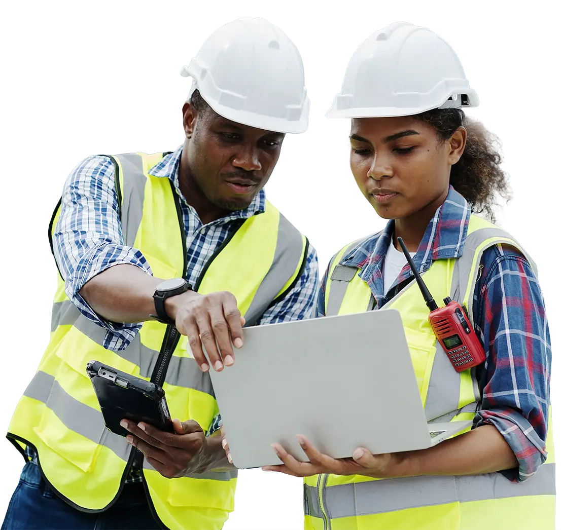 Two technicians wearing hardhats and looking at a computer together