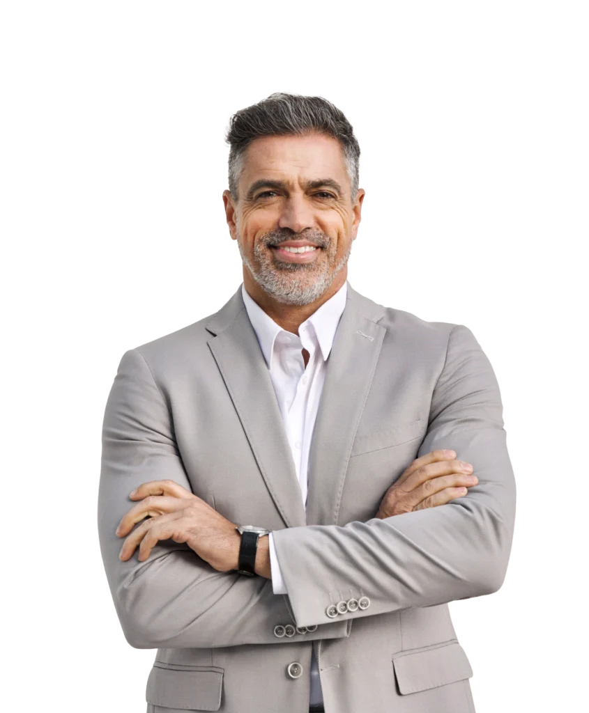 A man with his arms crossed, smiling, looking directly at the camera