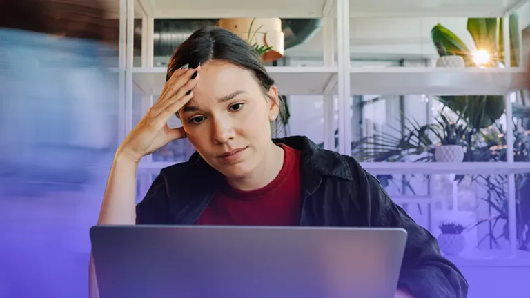 Frustrated woman looking at computer