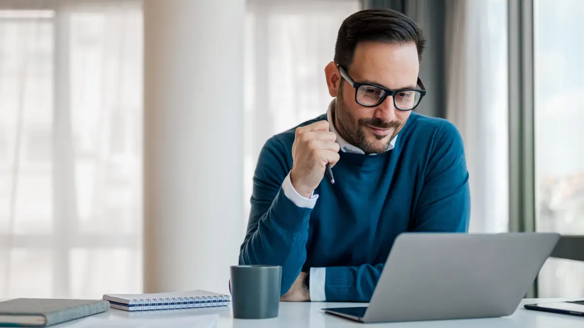 man looking at computer reading Billtrust velocity blog