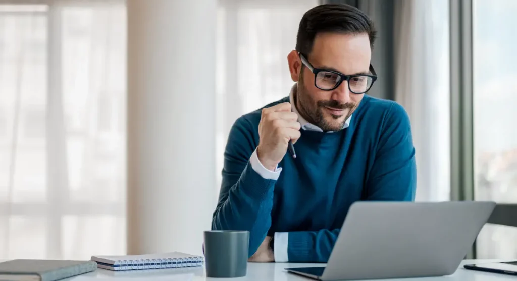 man looking at computer reading Billtrust velocity blog